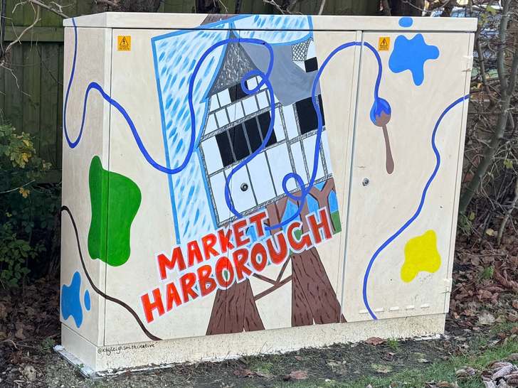Utility cabinet painted with a timber-framed building and ‘Market Harborough’ lettering